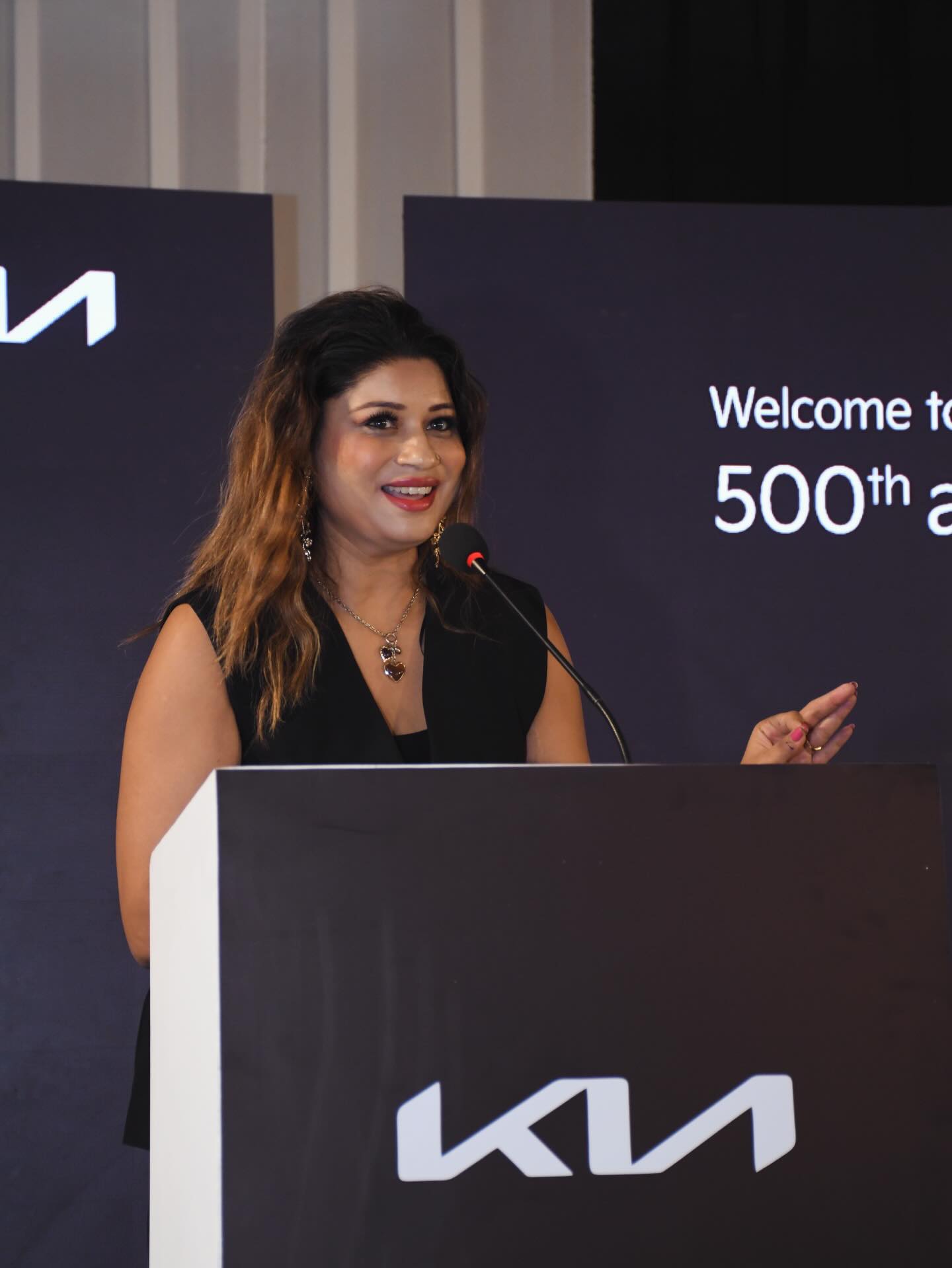 Monica hosting a Kia dealership milestone event